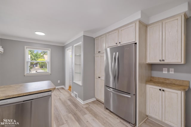23016 California St, Saint Clair Shores, MI 48080 - kitchen featuring appliances with stainless steel finishes, light countertops, light wood finished floors, light brown cabinetry, and baseboards