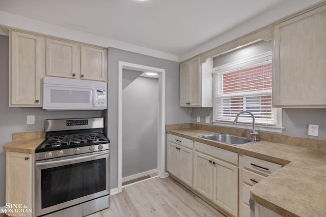 23016 California St, Saint Clair Shores, MI 48080 - kitchen featuring white microwave, gas stove, a sink, light brown cabinets, and light countertops