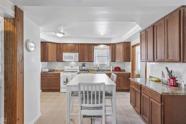 22301 Saint Gertrude St, Saint Clair Shores, MI 48081 - kitchen with white appliances, a sink, tasteful backsplash, and light tile patterned floors
