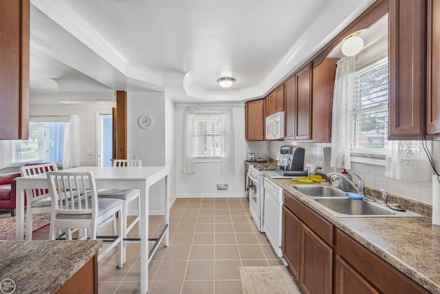 22301 Saint Gertrude St, Saint Clair Shores, MI 48081 - kitchen featuring white appliances, a sink, light tile patterned floors, a tray ceiling, and baseboards