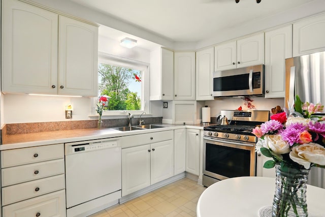 14810 28 Mile Rd, Washington, MI 48094 - kitchen featuring stainless steel appliances, a sink, light countertops, and white cabinets