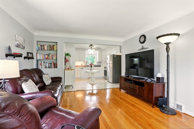 14810 28 Mile Rd, Washington, MI 48094 - living room featuring light wood-style flooring and ceiling fan