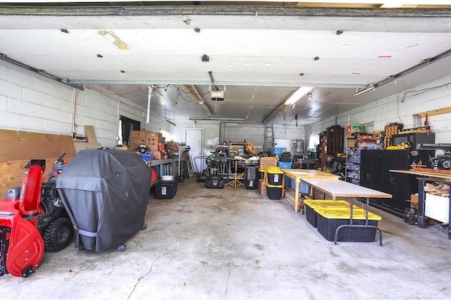 14810 28 Mile Rd, Washington, MI 48094 - garage with a workshop area, a garage door opener, and concrete block wall