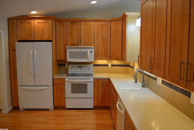 2423 Birchcrest Ct, Sterling Heights, MI 48314 - kitchen with white appliances, a sink, brown cabinets, light countertops, and recessed lighting