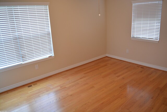 2423 Birchcrest Ct, Sterling Heights, MI 48314 - spare room featuring light wood-type flooring and baseboards