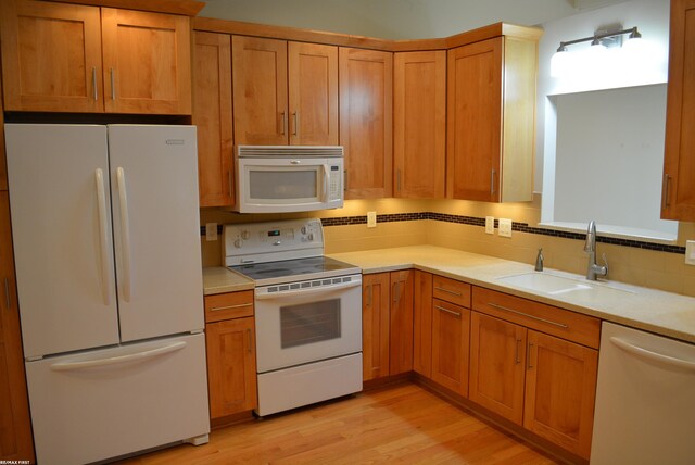 2423 Birchcrest Ct, Sterling Heights, MI 48314 - kitchen featuring white appliances, a sink, backsplash, light wood finished floors, and light countertops