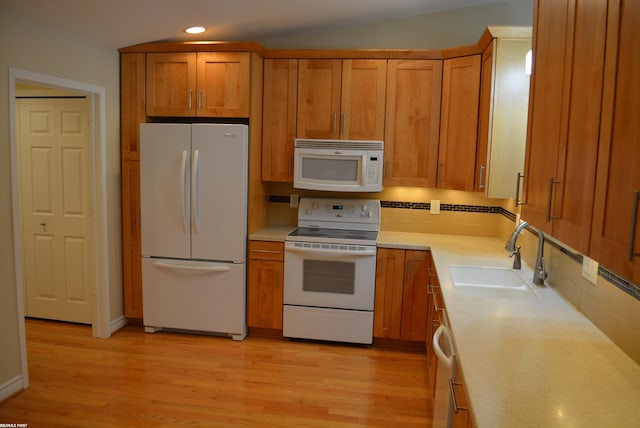 2423 Birchcrest Ct, Sterling Heights, MI 48314 - kitchen featuring white appliances, a sink, recessed lighting, brown cabinetry, and light countertops