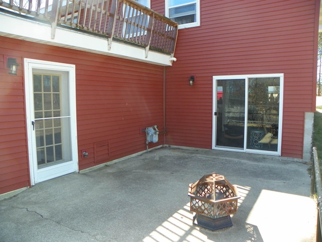 489 Broad St, Harrison, MI 48625 - view of patio with a balcony and a fire pit