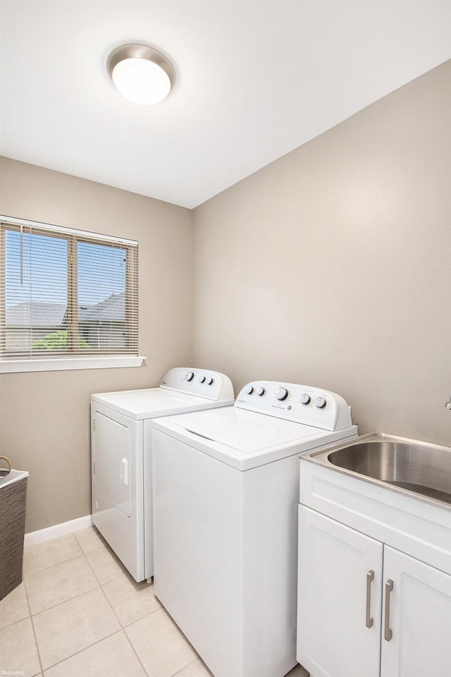 70226 Beebe St, Richmond, MI 48062 - washroom featuring washer and clothes dryer, cabinet space, light tile patterned flooring, and baseboards