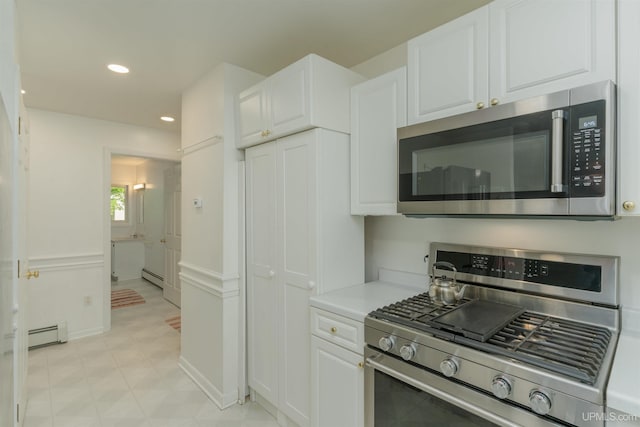12826 Section 16 Rd, Watton, MI 49970 - kitchen featuring stainless steel appliances, white cabinets, a baseboard heating unit, light countertops, and recessed lighting