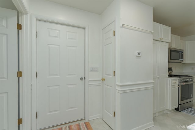 12826 Section 16 Rd, Watton, MI 49970 - kitchen with appliances with stainless steel finishes and white cabinets