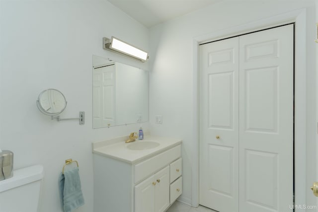 12826 Section 16 Rd, Watton, MI 49970 - bathroom featuring vanity, toilet, and a closet