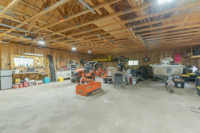12826 Section 16 Rd, Watton, MI 49970 - garage with a workshop area and freestanding refrigerator