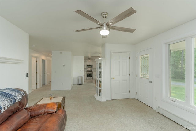 12826 Section 16 Rd, Watton, MI 49970 - living area with a ceiling fan, a baseboard heating unit, and light carpet