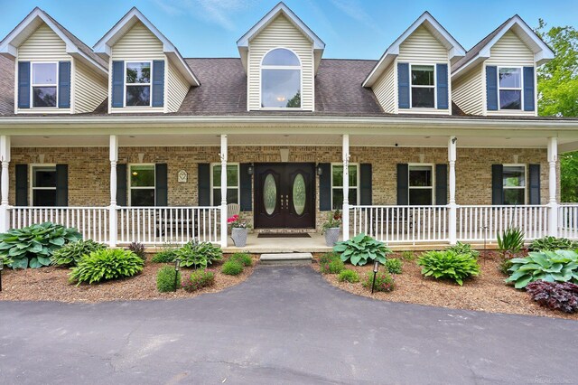 7859 Pine Ridge Dr, Clarkston, MI 48346 - cape cod home with covered porch and brick siding