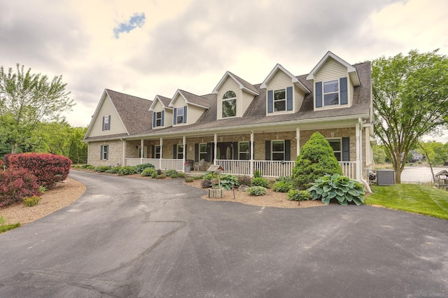 7859 Pine Ridge Dr, Clarkston, MI 48346 - cape cod-style house with central air condition unit, a porch, brick siding, and a shingled roof