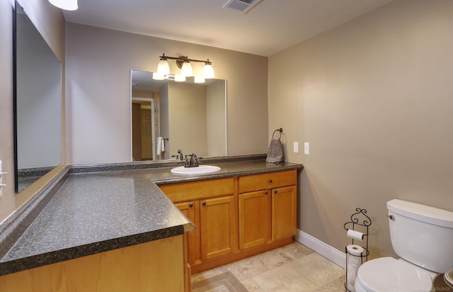 7859 Pine Ridge Dr, Clarkston, MI 48346 - bathroom with toilet, vanity, and baseboards
