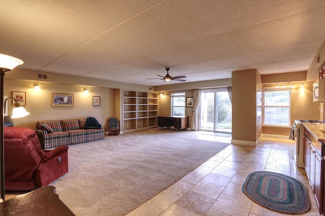 7859 Pine Ridge Dr, Clarkston, MI 48346 - living area featuring light colored carpet, ceiling fan, baseboards, a textured ceiling, and built in shelves