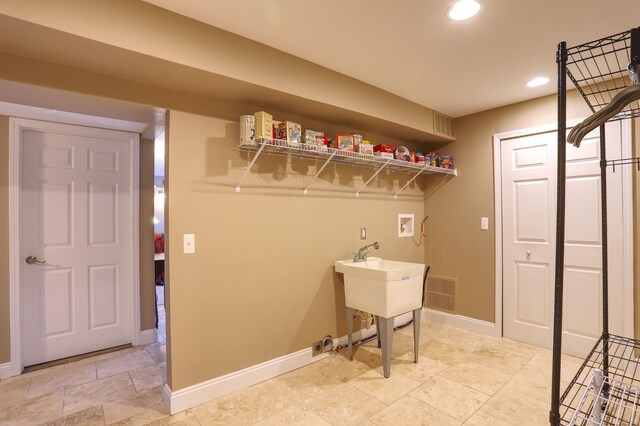 7859 Pine Ridge Dr, Clarkston, MI 48346 - washroom featuring washer hookup, baseboards, recessed lighting, bar, and light stone finish flooring