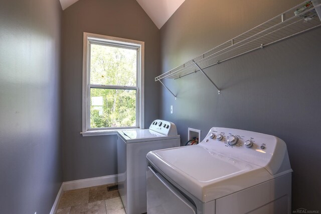 7859 Pine Ridge Dr, Clarkston, MI 48346 - laundry room featuring washer and clothes dryer, baseboards, and healthy amount of natural light