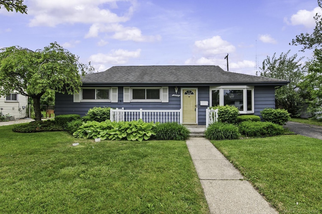 26657 Margaret St, Roseville, MI 48066 - bungalow with a front yard, covered porch, and a shingled roof