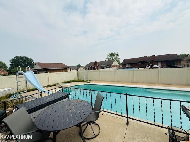 16754 Sarno Dr, Macomb, MI 48044 - view of pool featuring a water slide, a fenced backyard, and a patio area