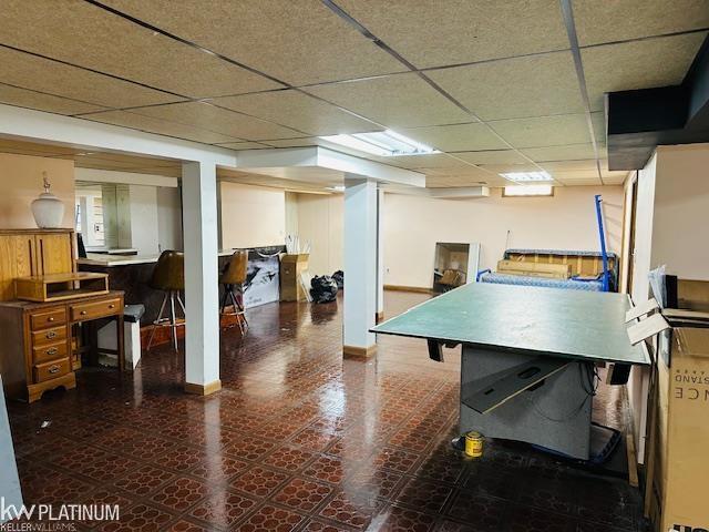 16754 Sarno Dr, Macomb, MI 48044 - recreation room with tile patterned floors, a drop ceiling, and baseboards