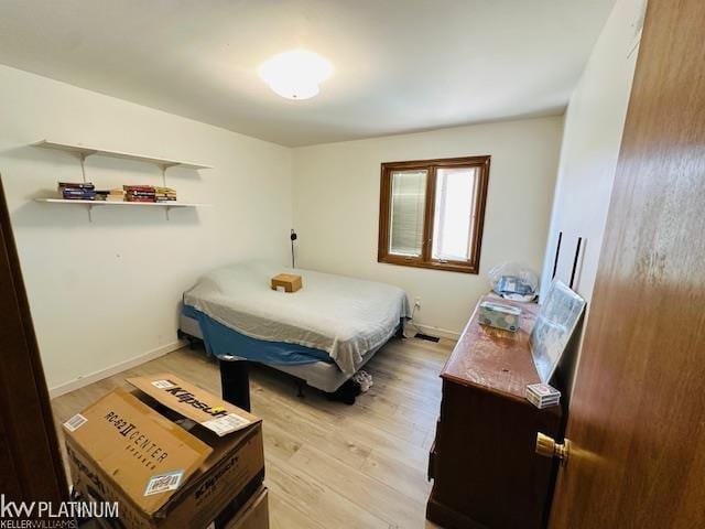 16754 Sarno Dr, Macomb, MI 48044 - bedroom with light wood-style floors and baseboards