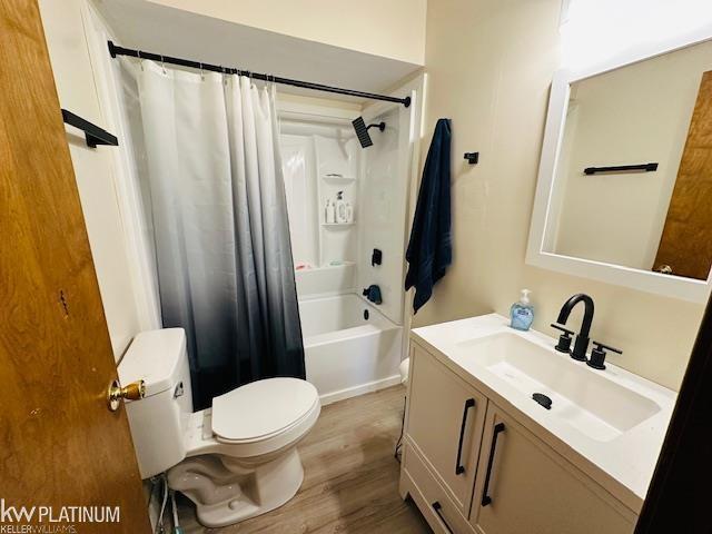 16754 Sarno Dr, Macomb, MI 48044 - bathroom featuring toilet, vanity, wood finished floors, and shower / bath combo with shower curtain