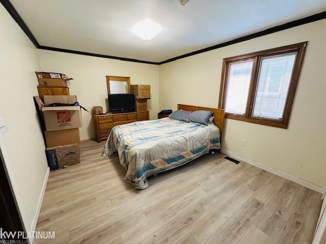 16754 Sarno Dr, Macomb, MI 48044 - bedroom featuring ornamental molding, light wood-style flooring, and baseboards