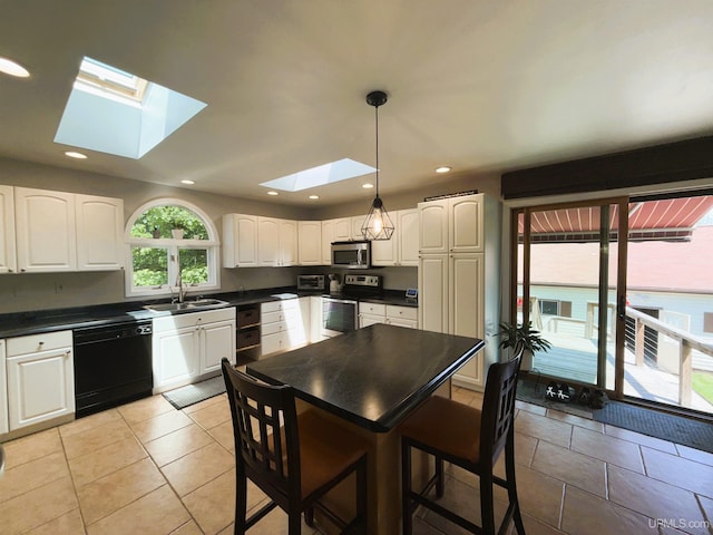 801 S Hemlock St, Iron Mountain, MI 49801 - kitchen with appliances with stainless steel finishes, a skylight, dark countertops, white cabinets, and a sink