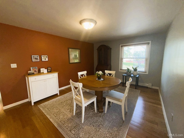 801 S Hemlock St, Iron Mountain, MI 49801 - dining area with baseboards, dark wood finished floors, and a baseboard radiator
