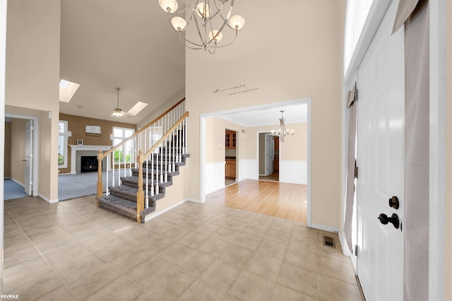 45259 Yorkshire Dr, Macomb, MI 48044 - foyer entrance featuring a high ceiling, a chandelier, a fireplace, stairs, and light tile patterned floors