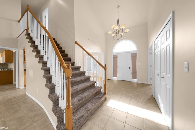 45259 Yorkshire Dr, Macomb, MI 48044 - entryway with a towering ceiling, stairs, light tile patterned flooring, a chandelier, and baseboards