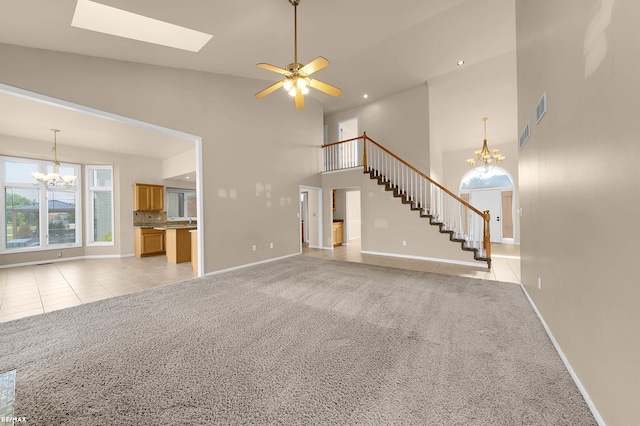 45259 Yorkshire Dr, Macomb, MI 48044 - unfurnished living room featuring a chandelier, a high ceiling, baseboards, a skylight, and light carpet
