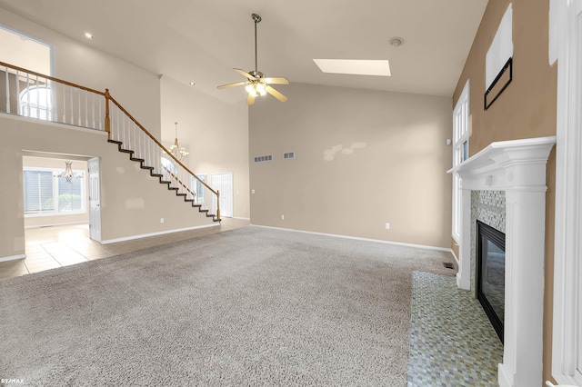 45259 Yorkshire Dr, Macomb, MI 48044 - unfurnished living room featuring high vaulted ceiling, a tile fireplace, a ceiling fan, a chandelier, and stairs