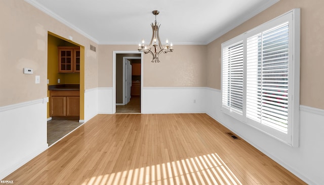 45259 Yorkshire Dr, Macomb, MI 48044 - unfurnished room featuring a chandelier, light wood-type flooring, healthy amount of natural light, and crown molding
