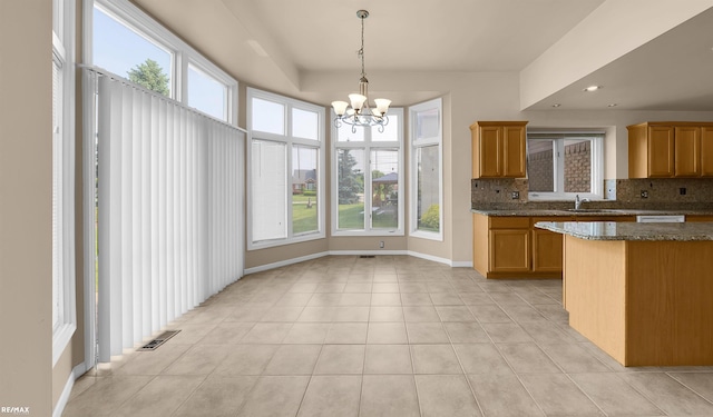 45259 Yorkshire Dr, Macomb, MI 48044 - kitchen featuring a sink, backsplash, healthy amount of natural light, a chandelier, and recessed lighting