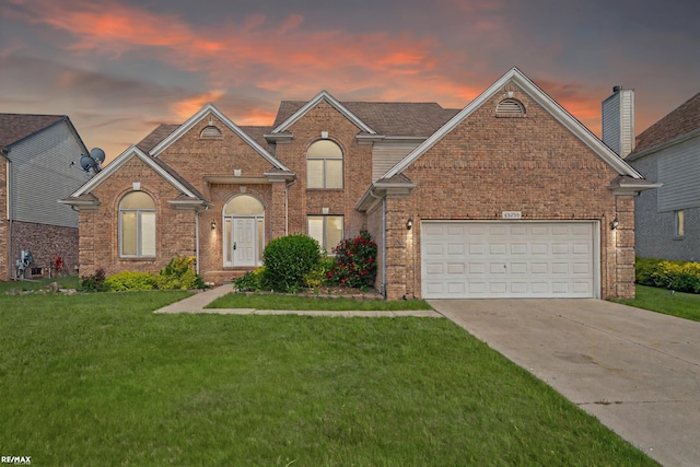 45259 Yorkshire Dr, Macomb, MI 48044 - traditional-style house featuring brick siding, a front lawn, driveway, and a garage