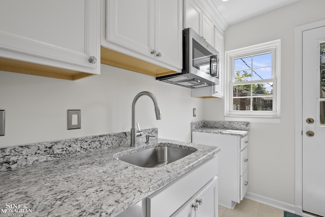 22920 Marter Rd, Saint Clair Shores, MI 48080 - kitchen featuring a sink, stainless steel microwave, light stone counters, white cabinetry, and light tile patterned flooring