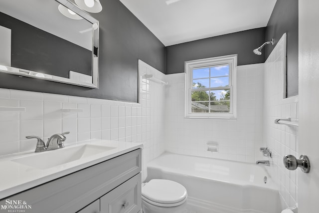22920 Marter Rd, Saint Clair Shores, MI 48080 - bathroom featuring tub / shower combination, vanity, toilet, tile walls, and a wainscoted wall