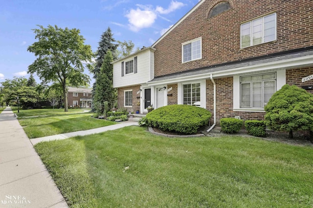 22920 Marter Rd, Saint Clair Shores, MI 48080 - view of front facade featuring brick siding and a front yard