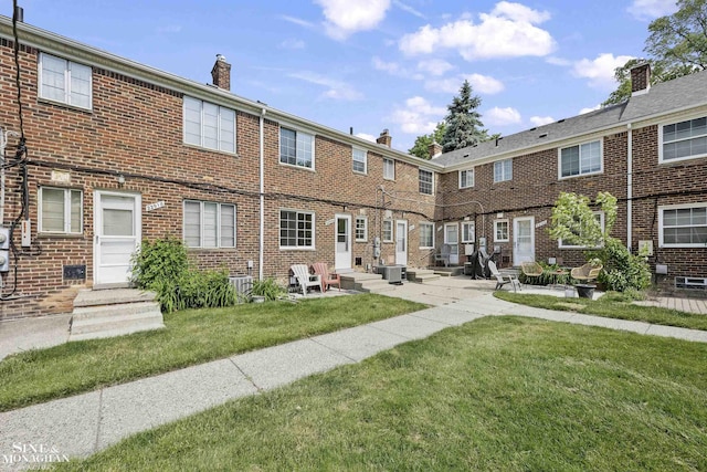 22920 Marter Rd, Saint Clair Shores, MI 48080 - rear view of property with a chimney, brick siding, a lawn, and a patio