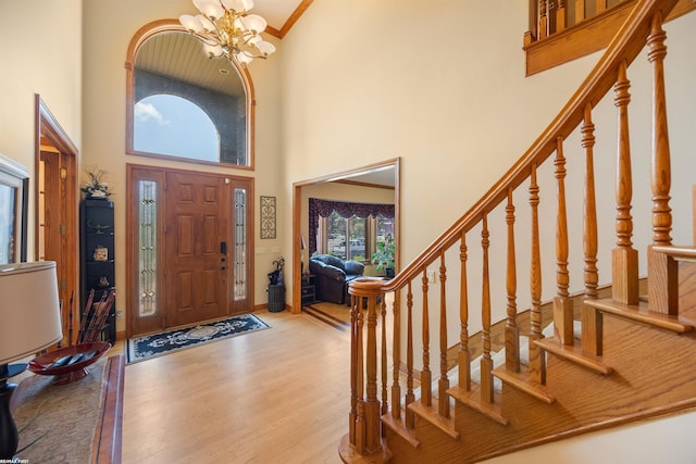 55733 Whitney Ct, Shelby Twp, MI 48315 - foyer with a towering ceiling, wood finished floors, a chandelier, stairs, and crown molding