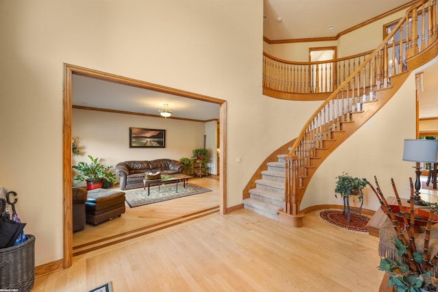 55733 Whitney Ct, Shelby Twp, MI 48315 - entrance foyer with wood finished floors, stairway, crown molding, and a towering ceiling
