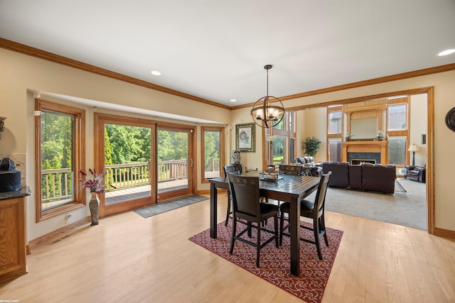 55733 Whitney Ct, Shelby Twp, MI 48315 - dining space featuring a chandelier, ornamental molding, light wood-style floors, a fireplace, and recessed lighting