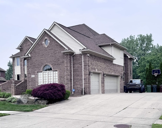 55733 Whitney Ct, Shelby Twp, MI 48315 - traditional-style house featuring a garage, driveway, brick siding, and roof with shingles