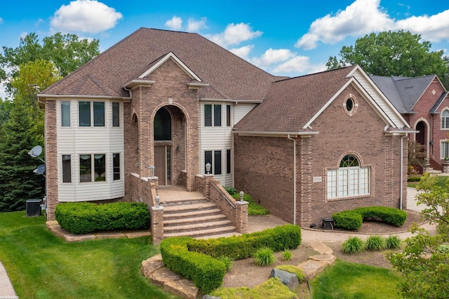 55733 Whitney Ct, Shelby Twp, MI 48315 - traditional-style home featuring brick siding, a front yard, and a shingled roof