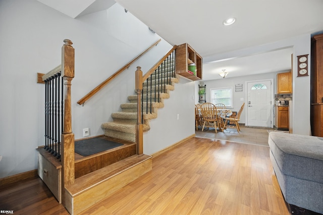 724 Columbia St, Algonac, MI 48001 - stairs featuring wood finished floors, baseboards, and recessed lighting