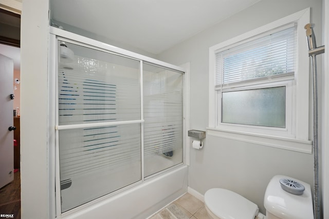724 Columbia St, Algonac, MI 48001 - bathroom with toilet, enclosed tub / shower combo, and tile patterned floors